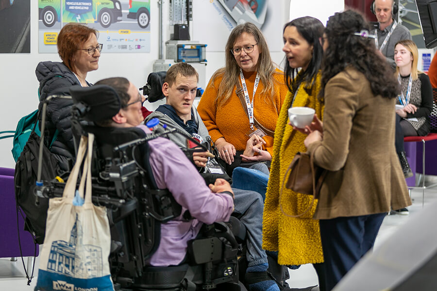 Six people in discussion at conference.