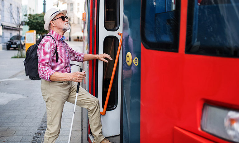 man getting on to a bus