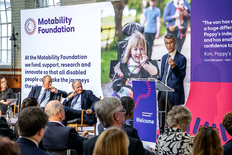 Paul Herriots speaking at a Motability Foundation meeting with audience in front listening.