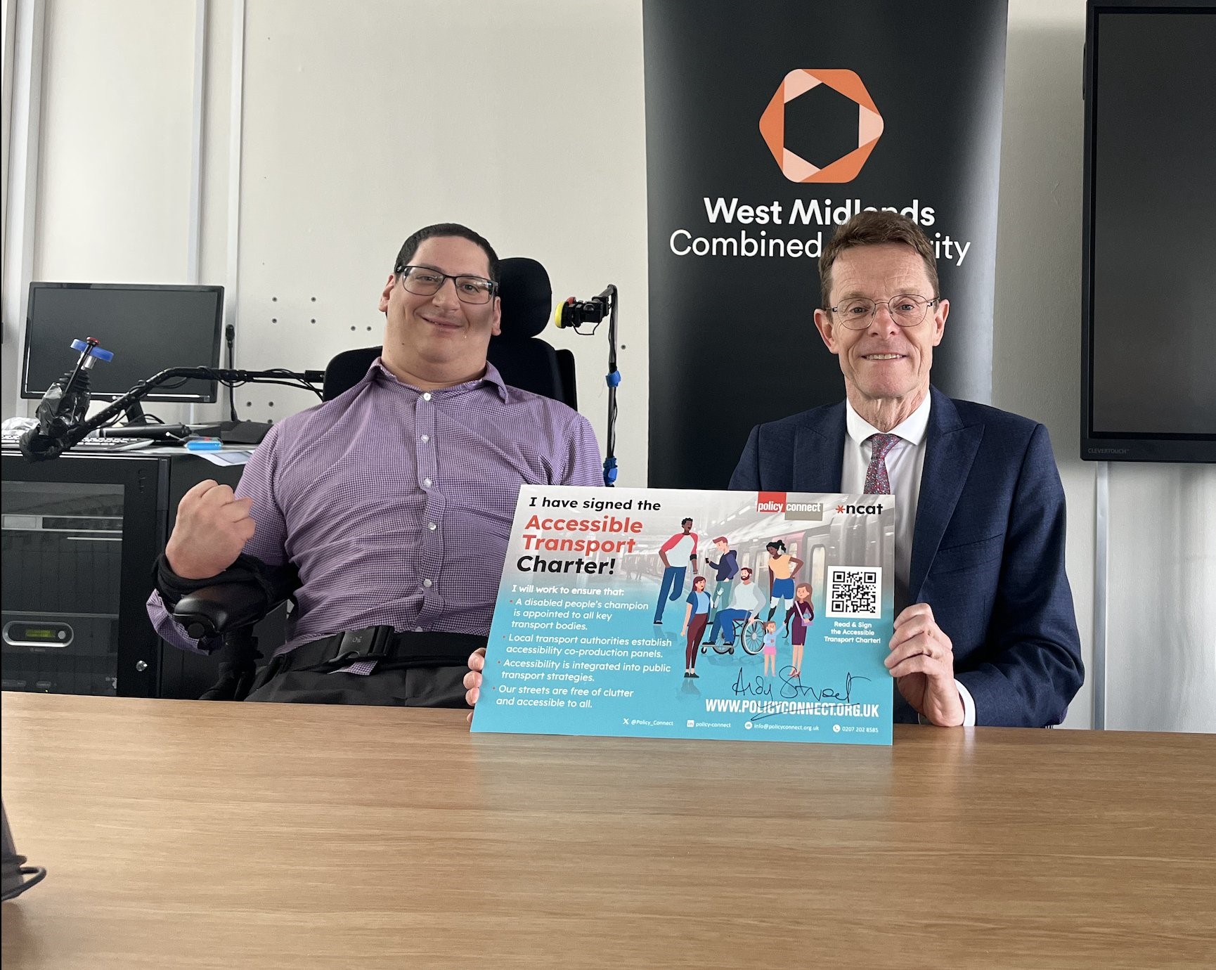 Clive Gilbert and Andy Street holding a copy of the Accessible Transport Charter